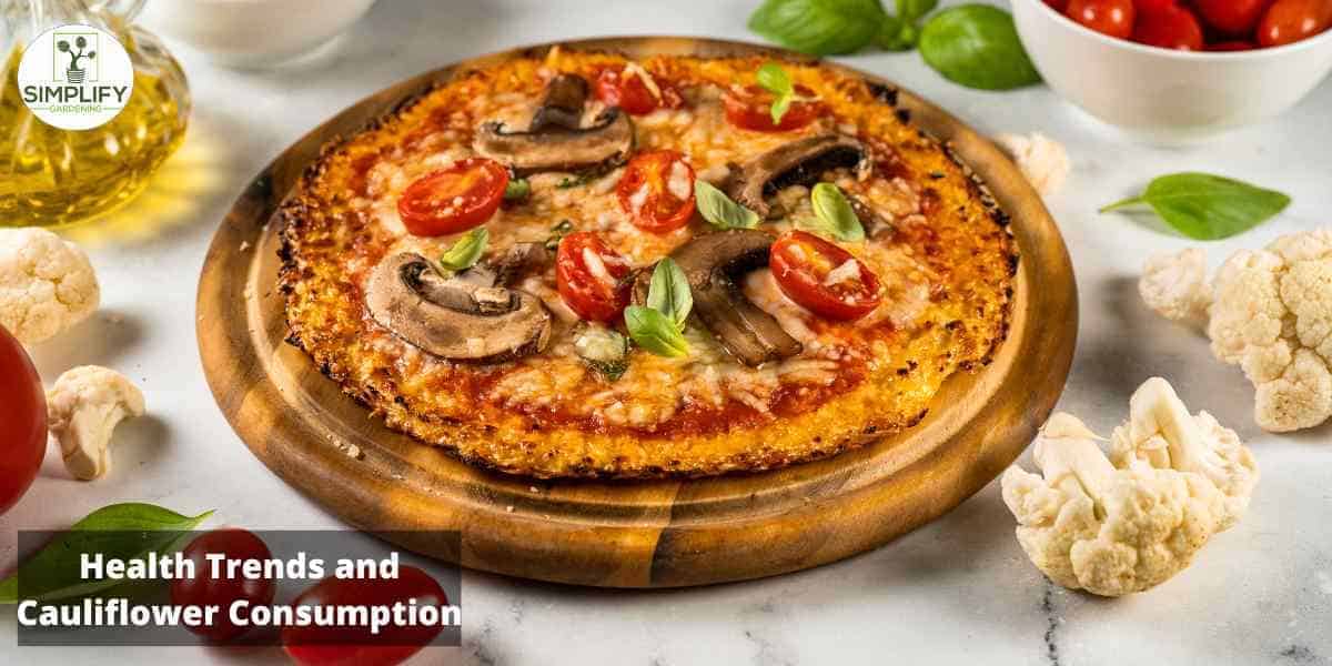 A pizza with golden brown crust and a variety of colorful toppings including cauliflower florets, tomatoes, and green onions. The cheese is melted and gooey, creating a delicious and inviting meal.